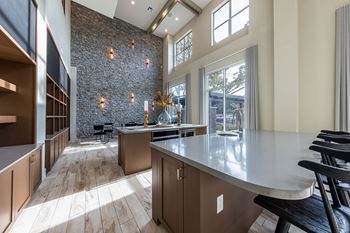 A large kitchen with a large island and a large window